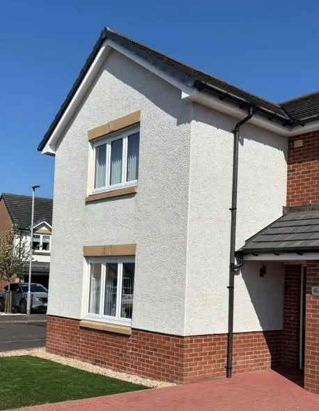 Render soft washed back to white on a detached house